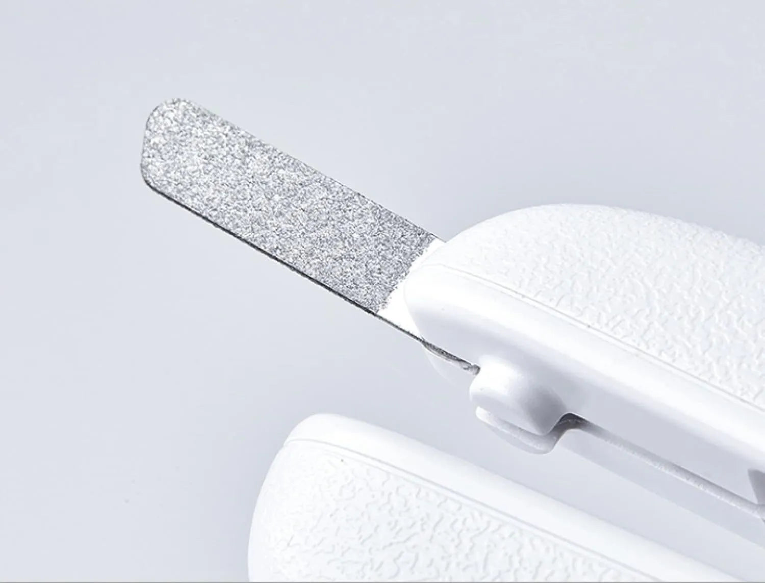 White LED pet nail clipper with transparent splash guard and triangular blade for cats and dogs