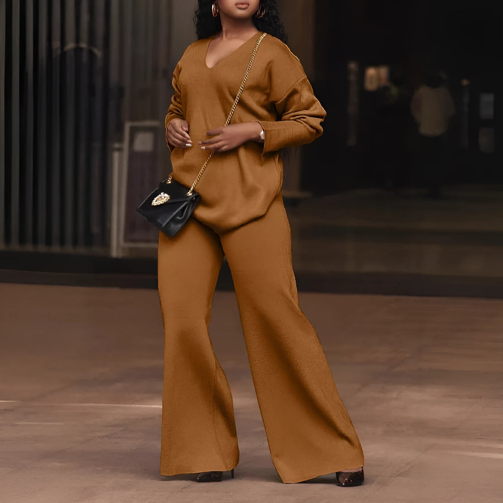 Women's brown thickened suede two-piece suit with split sleeve top and trousers on a hanger.