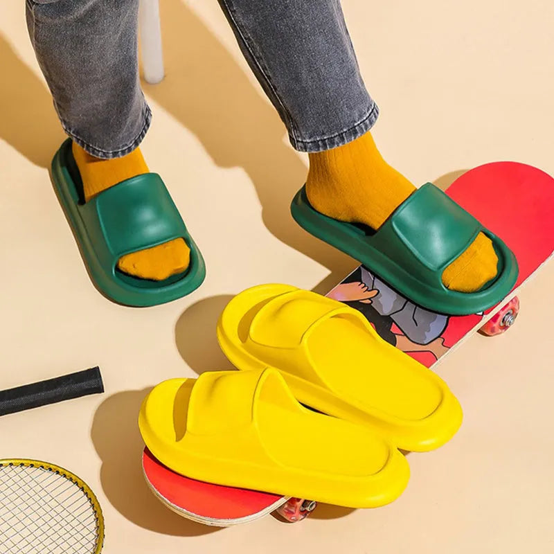 Unisex EVA flip-flop slippers with thick sole, shown in various colours on a bathroom tile floor.