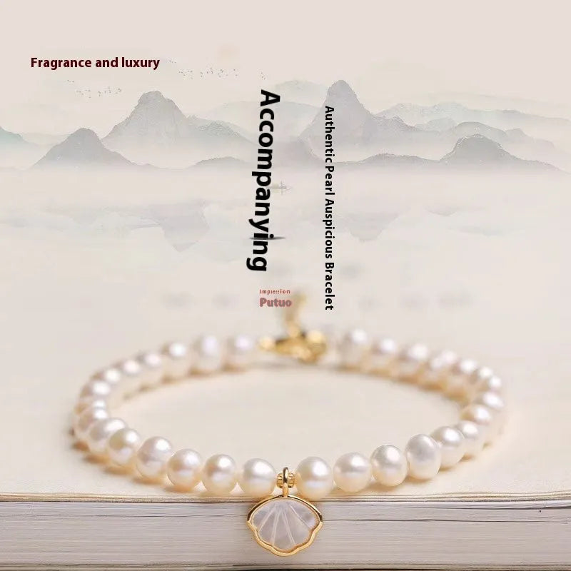 Freshwater pearl bracelet with fan-shaped pearl arrangement showing elastic string and extension chain fastening options