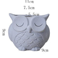 Handmade frosted ceramic flower pot with a cartoon owl design, shown in light pink.