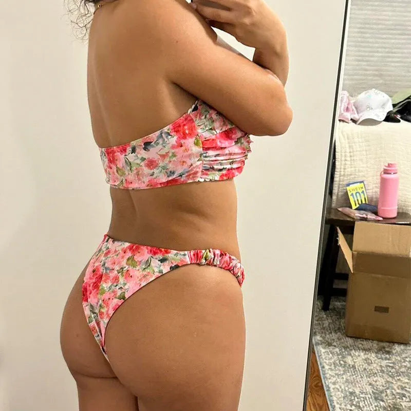 Colourful floral print bikini set with tube top and briefs on a hanger.