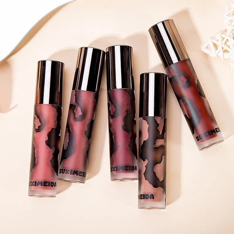 Matte lip mud lipstick in tube showing five colour shades: orange brown coffee, cool grey, cinnamon coffee, jujube red, smoked purple.