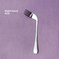 Stainless steel adaptive spoon for elderly feeding care, left hand version on white background