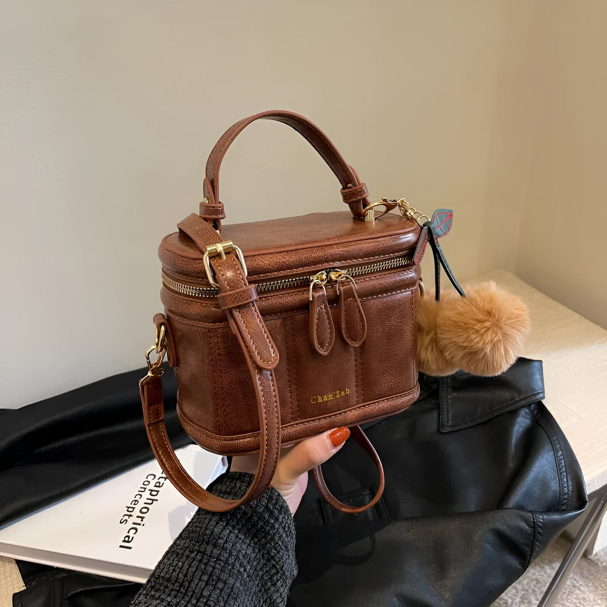 Box bucket bag in PU material with sewing line detail, available in Black, Brown, and Coffee, includes a free pendant