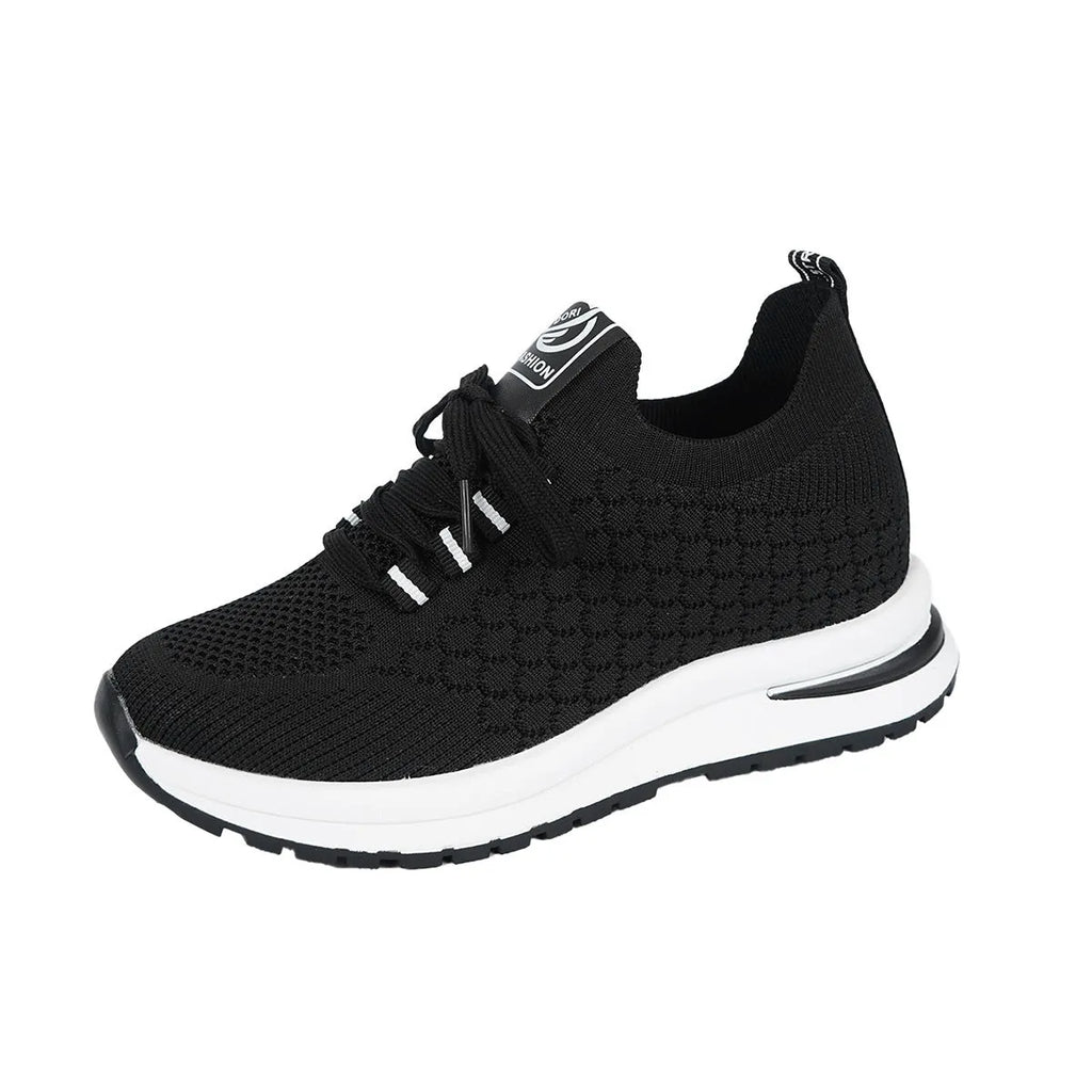 Women's black lace-up mesh sneakers with a flat rubber sole and round toe on a white background.
