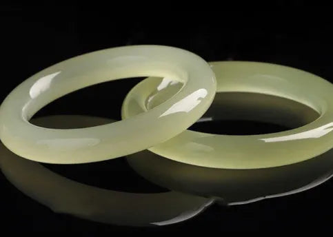 Adjustable winding bracelet made of round ice-like silk jade beads on a silk cord.
