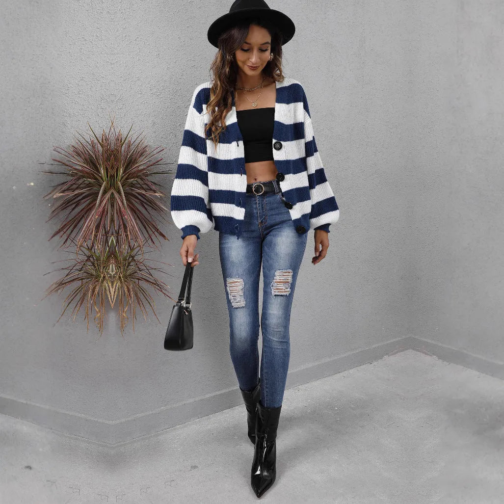 Blue striped women's cardigan with button front and deer plush textured fabric on a hanger.