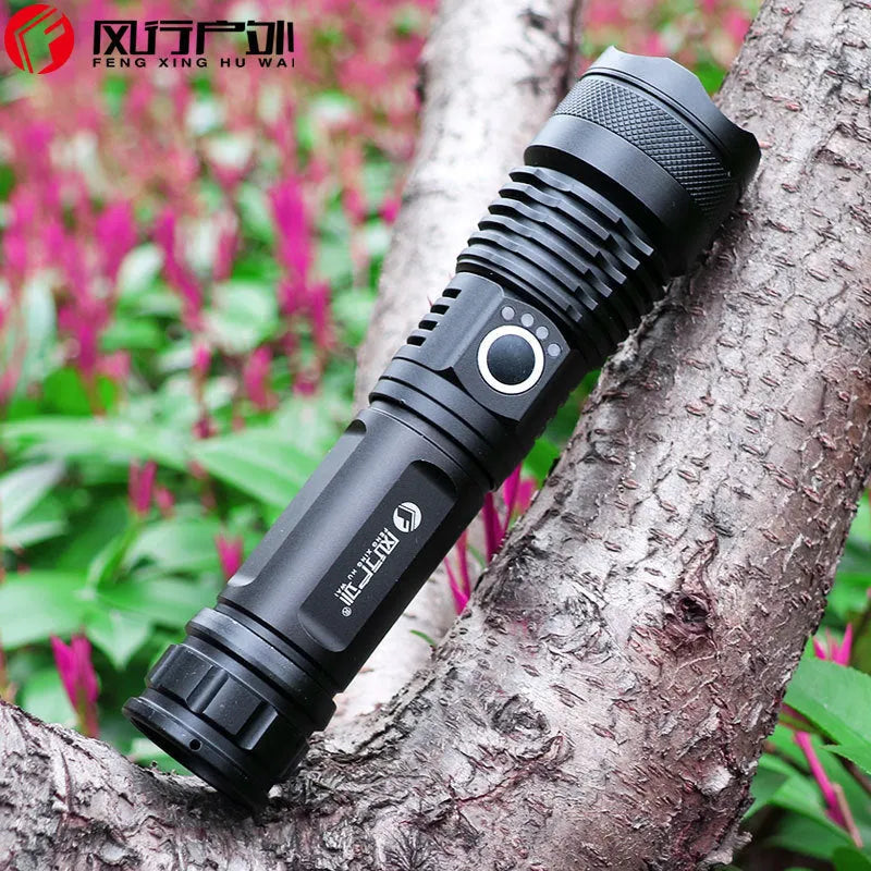 Black aluminium alloy rechargeable LED flashlight with zoom lens on grey background