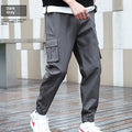 Khaki multi-pocket harem trousers with tapered mid-waist and elastic waistband, polyester fabric