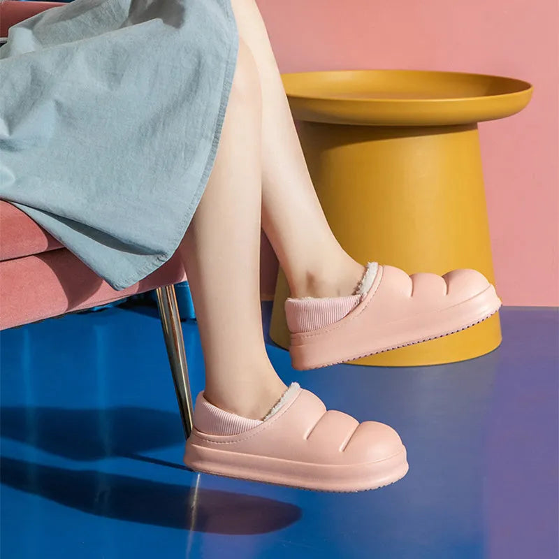 A pair of waterproof EVA couple slippers in various colours, showing plush lining and a non-slip sole.