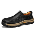 Men's black thick-soled mountaineering leather shoes with round toe and visible stitching on a natural background.