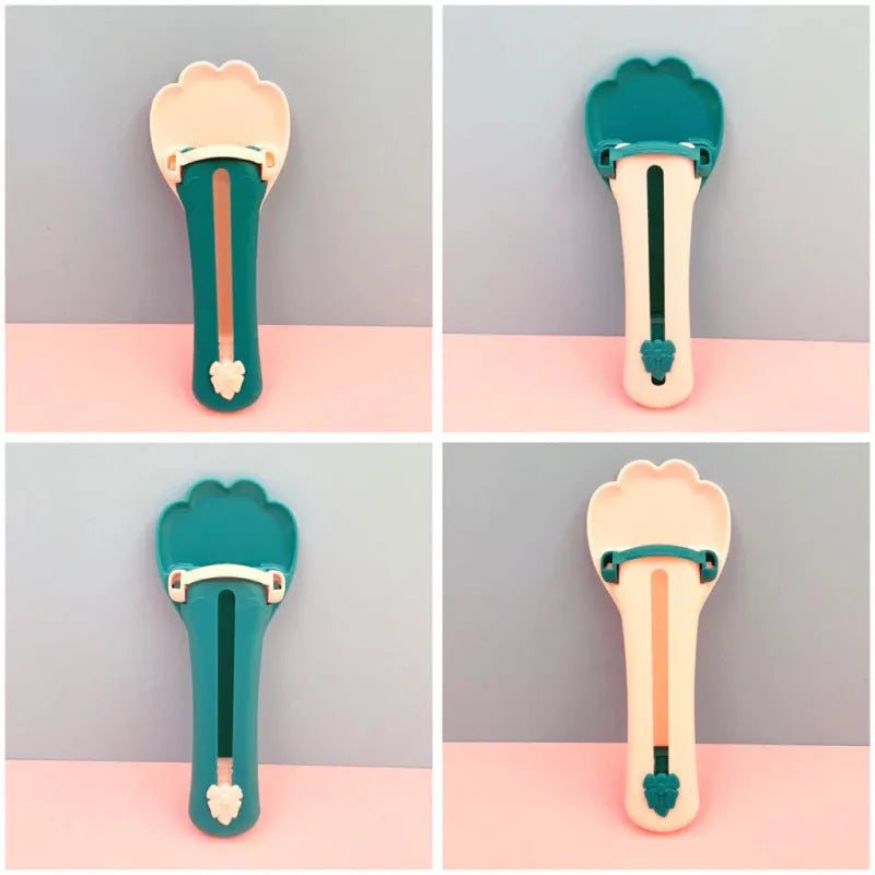 Green and pink pet feed spoon with squeeze mechanism for dispensing liquid food and treats