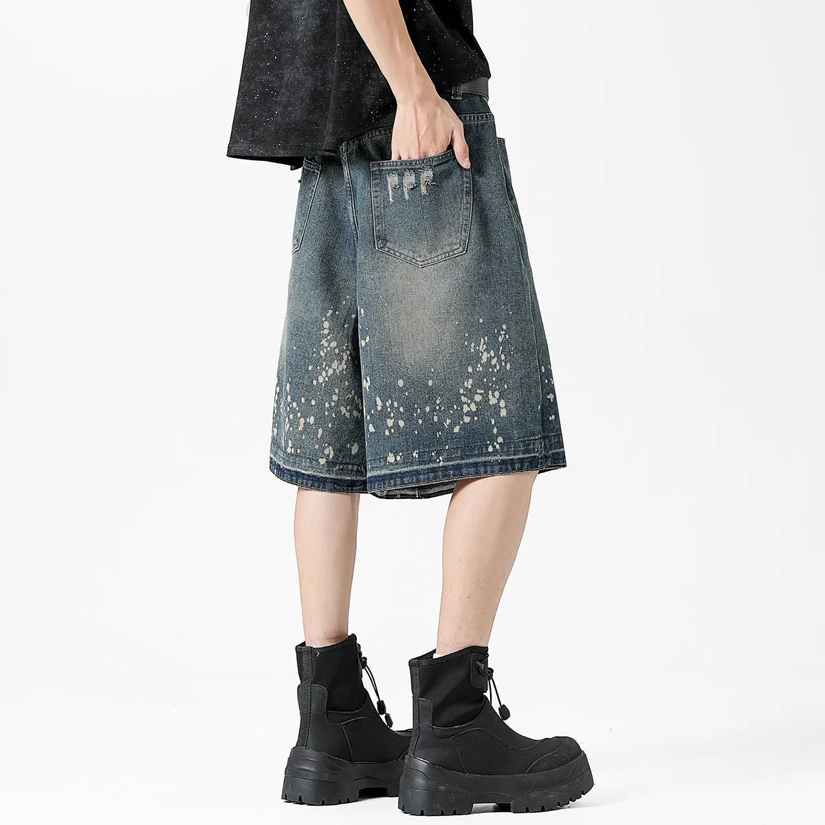 Retro blue washed denim shorts for men with a splash ink pattern and ripped detailing on the legs.