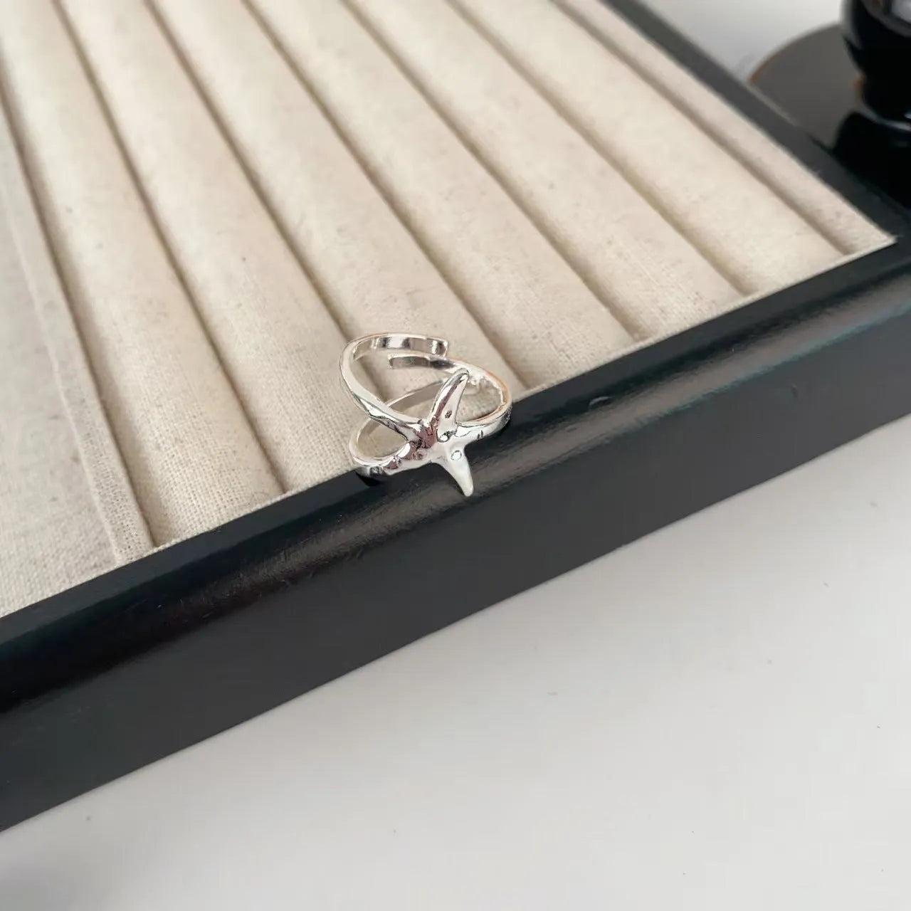 3D jasmine flower adjustable ring in zinc alloy with electroplated finish on a hand.