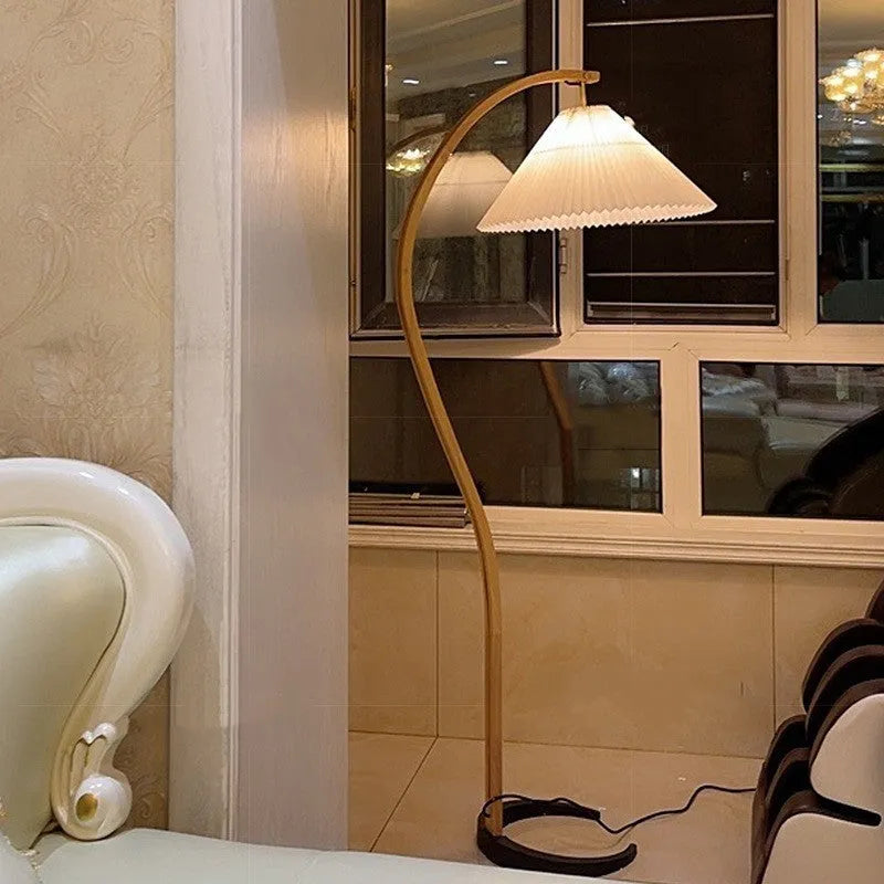 Vertical retro table lamp with a choice of log white or wine red lampshade on a wooden surface.