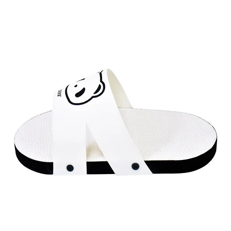 White corrugated paper cat scratch board in a slipper shape on a floor.