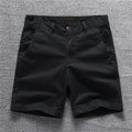 Men's green camouflage cotton workwear shorts with zip fly on a mid waist.