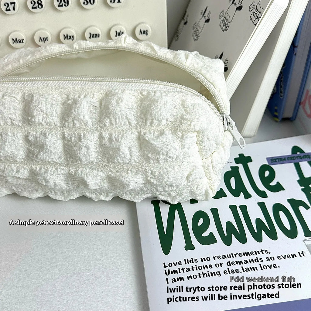 Cream puff style fabric pencil case in beige or black with zip closure