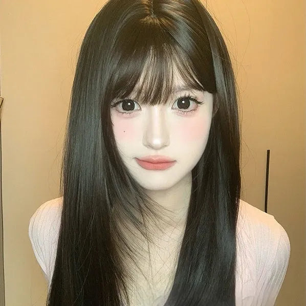 Dark brown long straight synthetic women's wig with a fringe on a wig head.