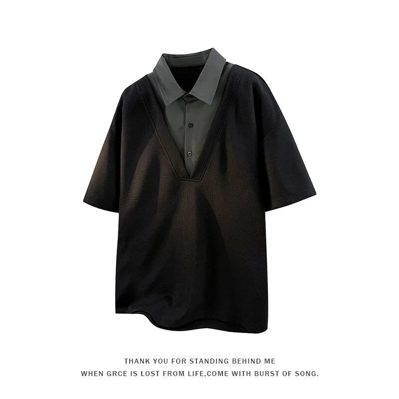 Man wearing a black padded Henry collar polo shirt sweater with short sleeves.