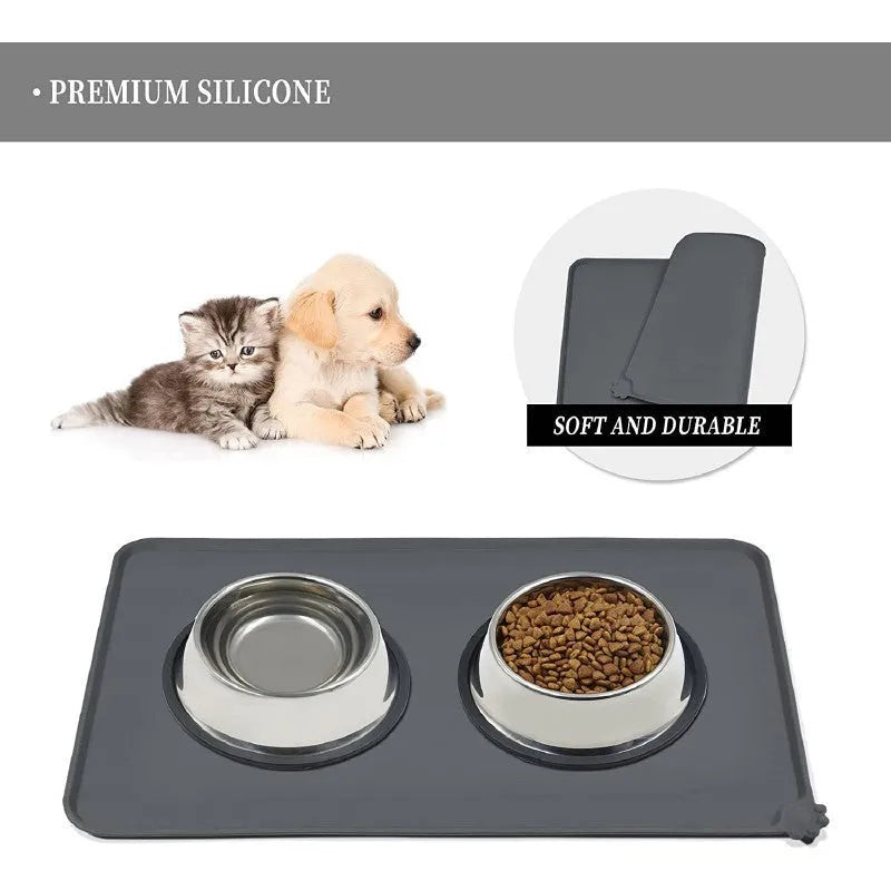 Silicone pet placemat under dog food and water bowls in a grey colour on a wooden floor.