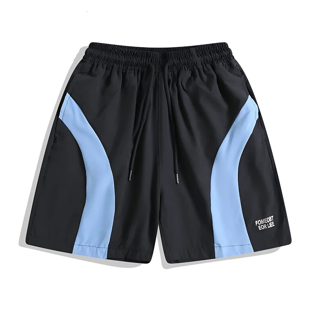 Man wearing loose-fitting black quick-dry sports shorts with an elastic waist for training.