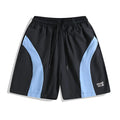 Man wearing loose-fitting black quick-dry sports shorts with an elastic waist for training.