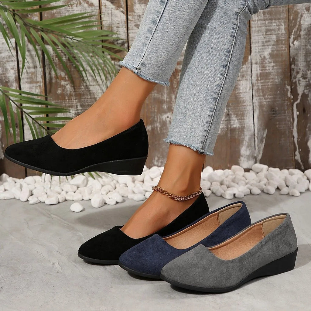 Women's pointed toe suede wedge pumps in light brown with a shallow mouth and low rubber sole.