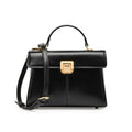 Women's black leather shoulder bag with clasp closure and adjustable strap showing interior organisation