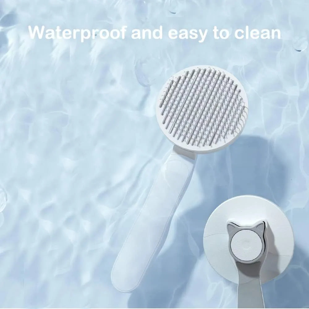 Blue self-cleaning cat brush with rubber-tipped pins and a one-click button on the handle