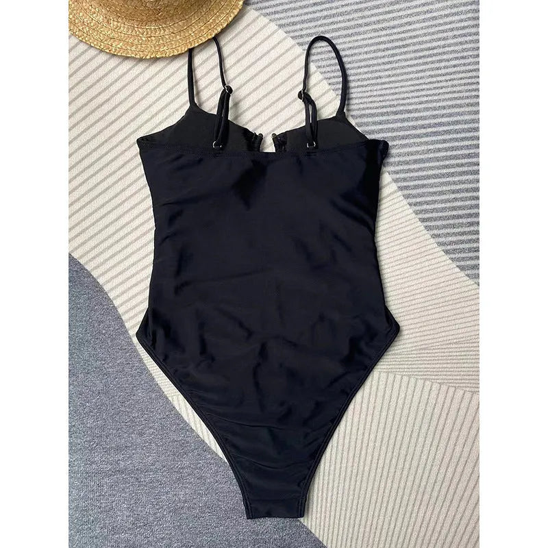 Black women's one-piece swimsuit on hanger showing form-fitting nylon design