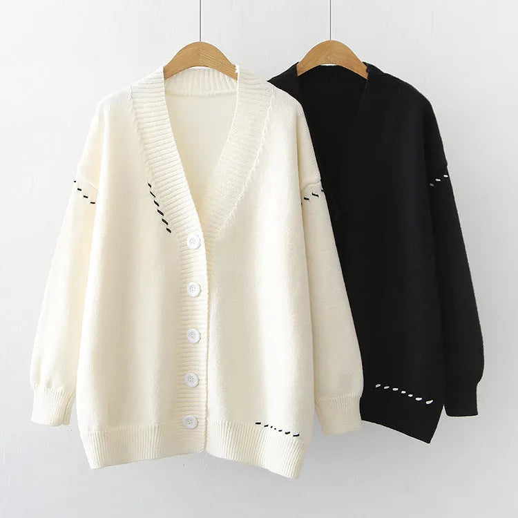 Women's loose fit knitted cardigan coat in black or white polyester with long sleeves