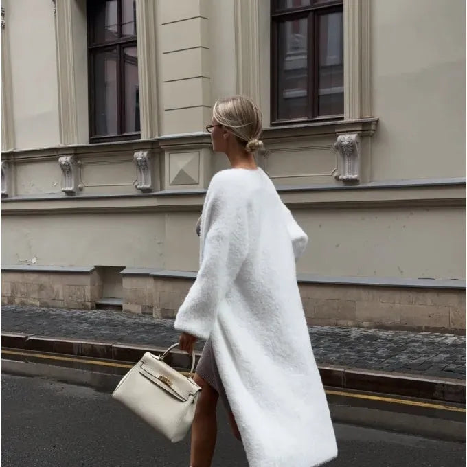 White knitted women's cardigan jacket with extended length and loose fit