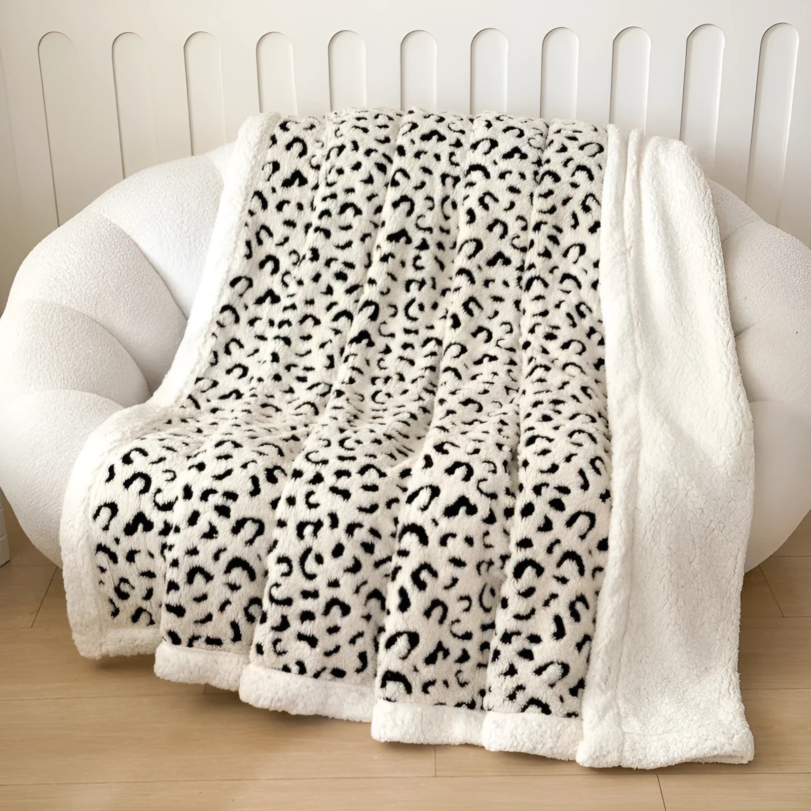 Double-layer jacquard taffeta blanket with leopard print pattern in a camel colour, laid flat on a bed.
