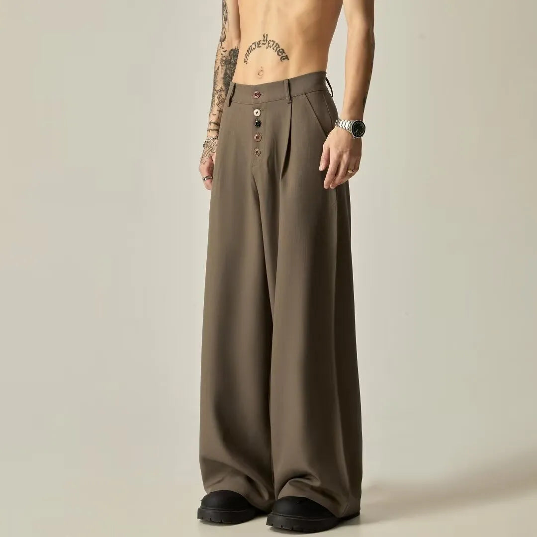 Men's black casual trousers with wide-leg design and button fly closure showing elastic waistband detail
