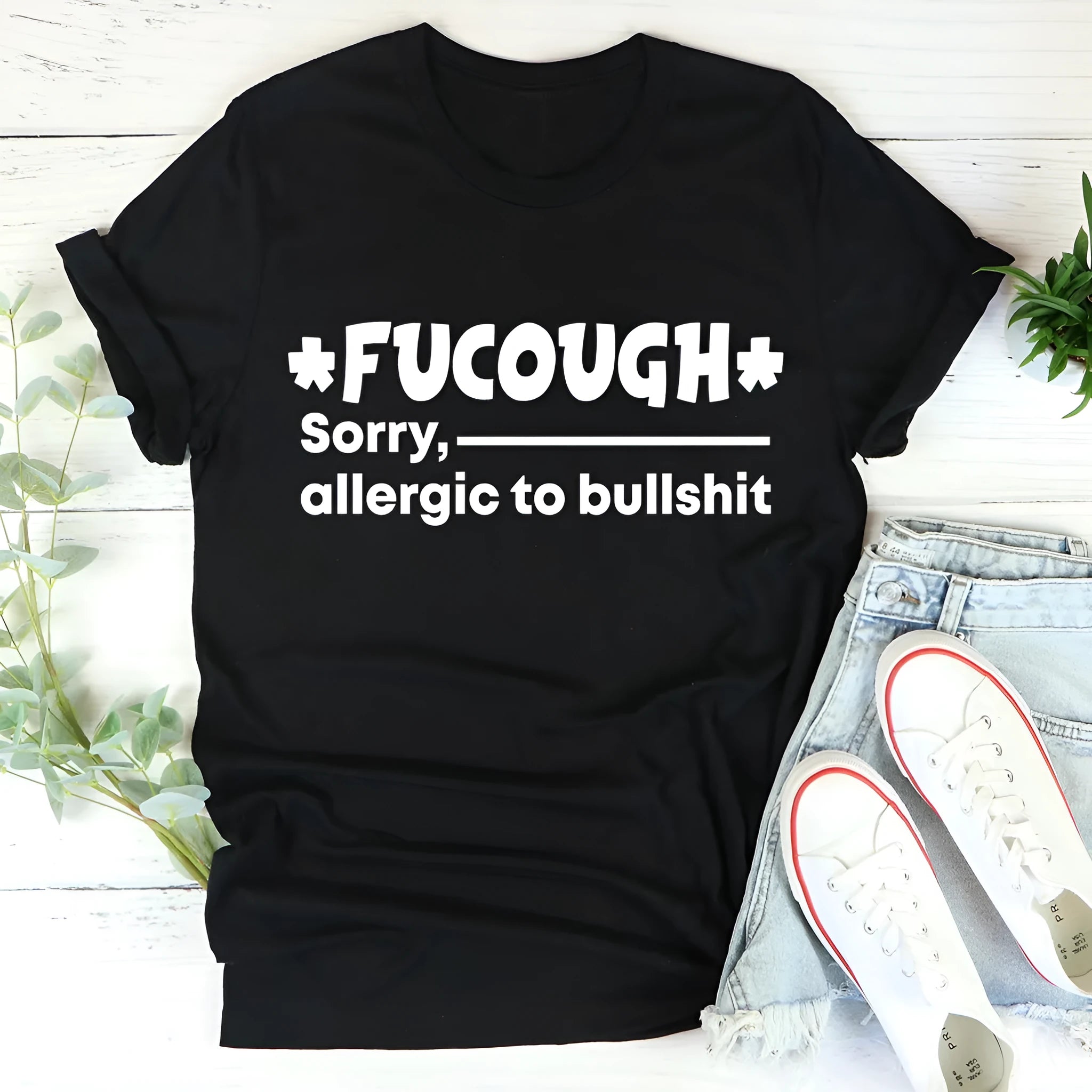 Black straight cut cotton T-shirt with round neck and short sleeves laid flat.