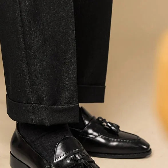 Black and brown business casual loafers with tassel detail and genuine leather upper