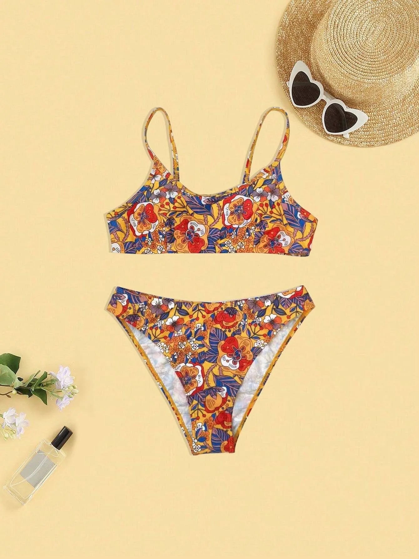 Plus size women's floral print strap bikini swimsuit two-piece set on a mannequin