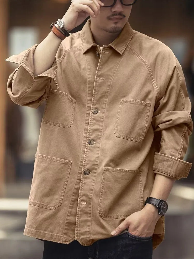 Men's khaki cotton blend denim jacket with loose fit and multiple pockets on a plain background