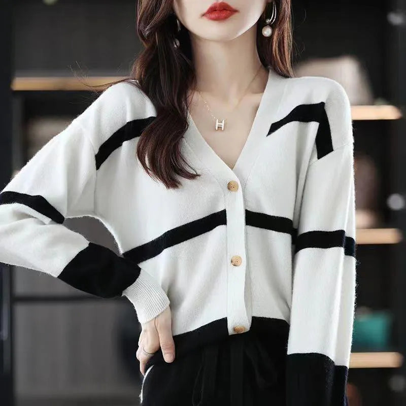 Women's black and white striped knitted cardigan with 3D pattern and V-neck.