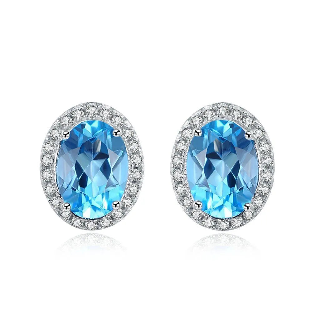 925 sterling silver jewellery set with blue topaz stones showing earrings, ring, pendant and necklace in geometric design
