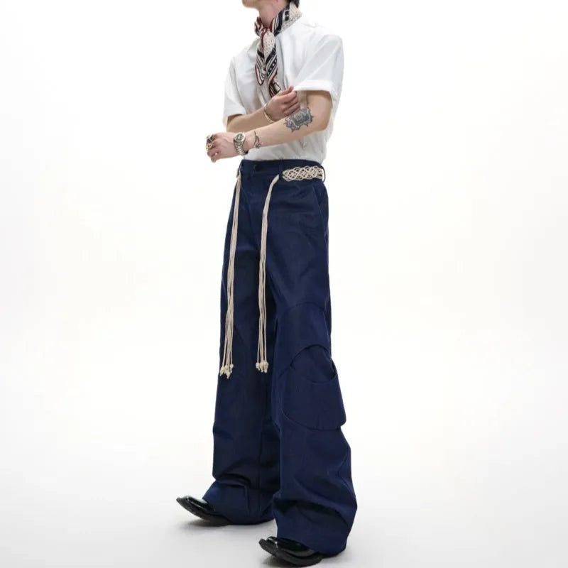Men's heavyweight cotton straight-leg jeans with 3D cutting, decorative zipper details, and tassel accents in dark colours