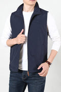 Man wearing a khaki casual waistcoat with side pockets over a blue shirt.