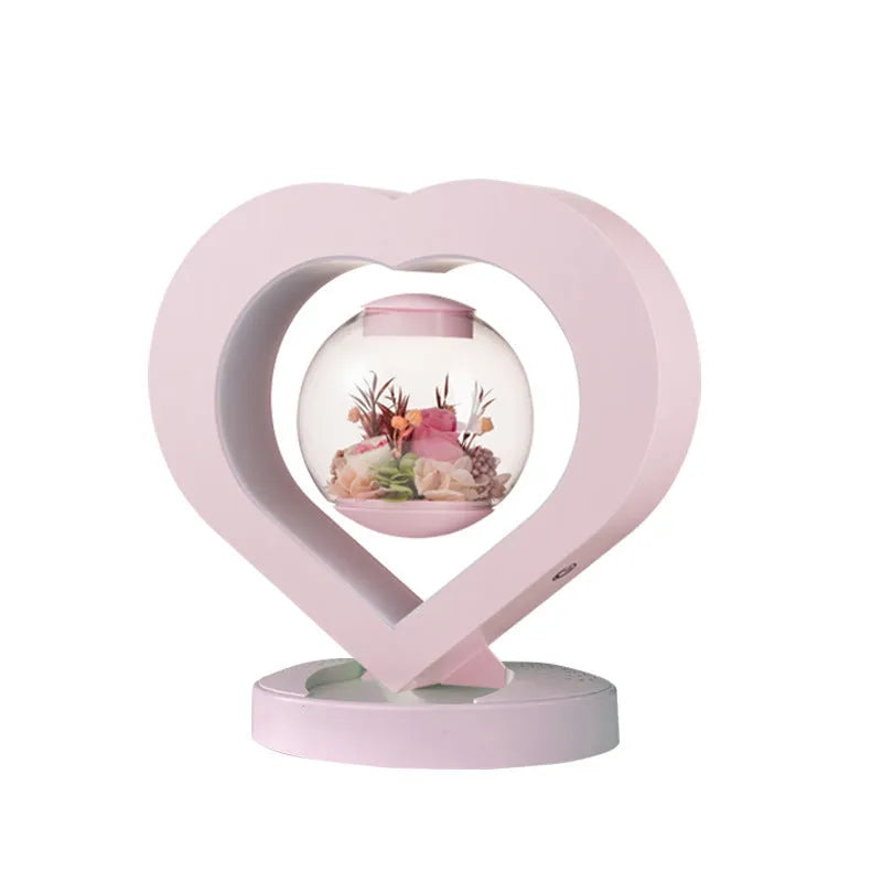Pink preserved real rose ornament with optional base and Bluetooth audio speaker.