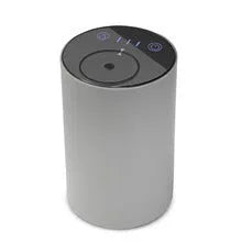 Black rechargeable car air freshener diffuser with automatic mist spray in vehicle cup holder
