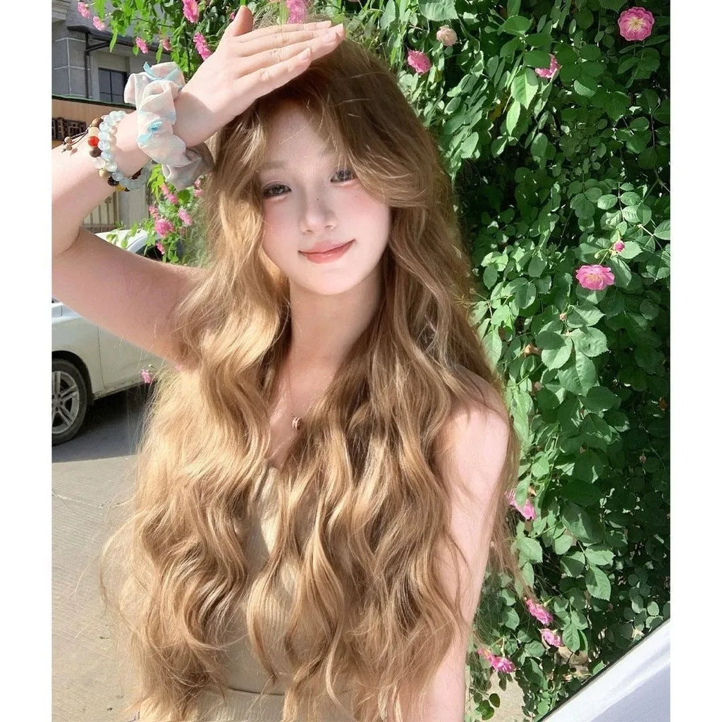 A brown curly synthetic wig with a linen hue and medium length on a wig stand.