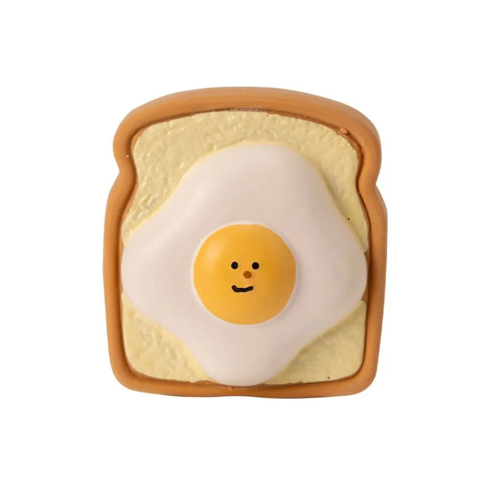 Yellow latex dog chew toy shaped like cartoon bread with squeaker inside