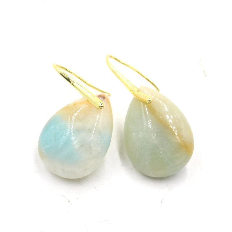 Geometric water drop shaped stud earrings with a central crystal in one of nine colour options on an electroplated metal base.