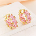 Geometric U-shaped gold ear ring with round black zircon stones